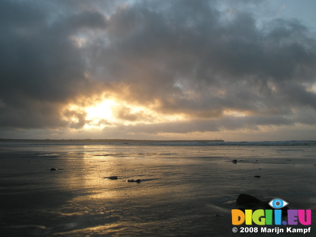 JT00131 Sunrise over pebble on Tramore beach (Brownstown head)